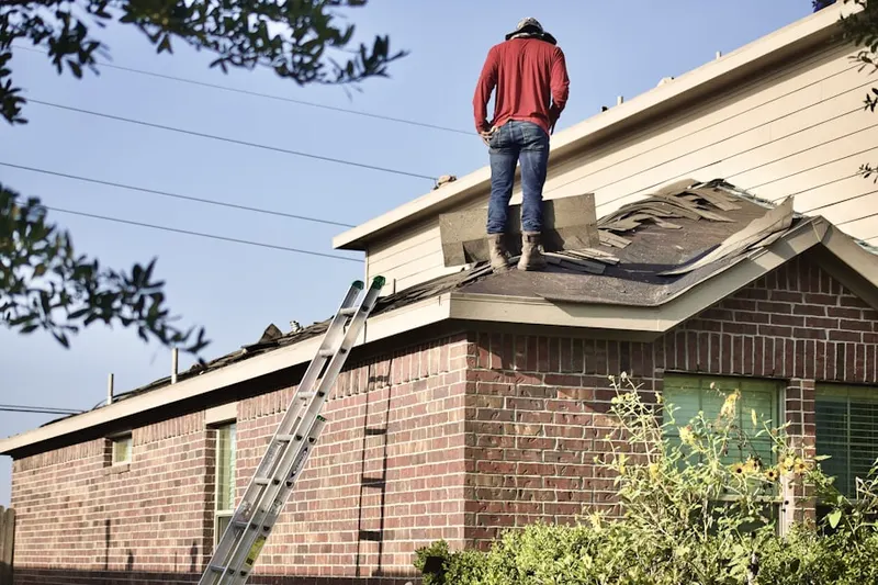 Professional roofer working on a residential roof in Wengerlawn